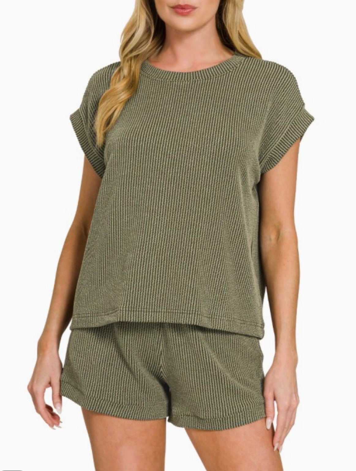 Model wearing an olive green ribbed lounge set featuring a relaxed short sleeve top and matching elastic waistband shorts.