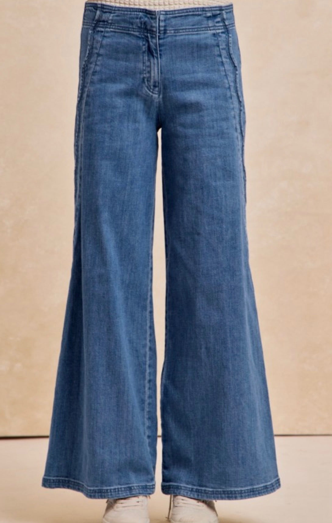 Blue jeans on a beige background