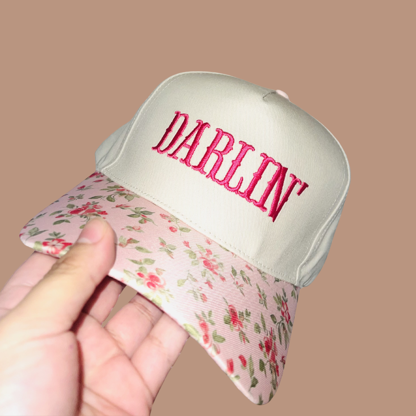 Cap with floral brim and 'Darling' embroidery on a beige background